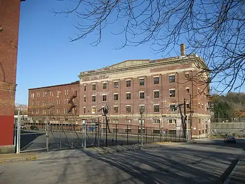 Former Oliver Ditson Company building, 166 Terrace Street, in the Mission Hill neighborhood of Roxbury, Massachusetts, later gutted and re-built as luxury apartments. Building inscription reads "Oliver Ditson Co. 1835-1925".