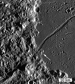 The arrow points to lava domes to the south of a linear rille