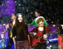 Raven and Larsen, two young teen girls, singing and playing guitar respectively