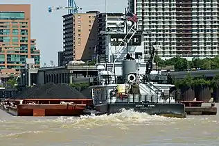 A barge hauls coal in the Louisville and Portland Canal, the only artificial portion of the Ohio River.