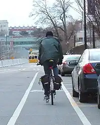 Cyclist riding in a bike lane situated in a door zone