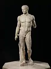 A Roman copy in marble of the original Greek bronze statue of a standing man in contraposto pose