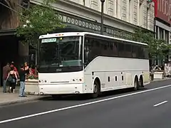 White bus parked on a city street