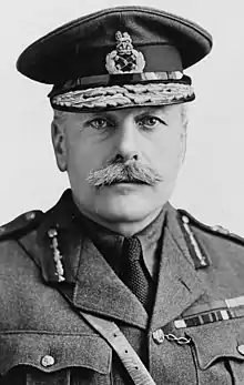 A man with a moustache wearing an army uniform and decorated cap