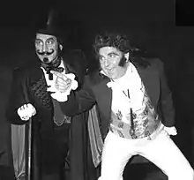 two men in 19th century costume in comically melodramatic pose