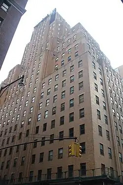 The BellTel Lofts, a 27-story brick building, as seen from ground level on a sunny day