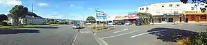 Maungaraki's shopping centre (right) in 2018, with Maungaraki Baptist Church (left)