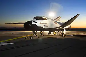 A spaceplane sits on a runway