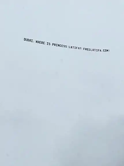 Banner against a cloudy sky, reading: DUBAI, WHERE IS PRINCESS LATIFA? FREELATIFA.COM