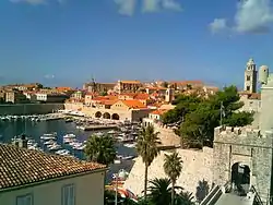 Marina in a city with churches and a fort.