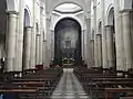 The central nave. Behind the altar, the panel painting that replicates the original viewing on the Cappella della Sacra Sindone (Chapel of the Holy Shroud) with the Altar of Bertola. Both works have been seriously damaged during the fire of 1997 and are still under restoration