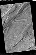 Layered features on floor of Hellas Planitia, as seen by HiRISE under HiWish program  This may be an example of honeycomb terrain that is not yet completely understood.