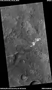 Contact showing light and dark-toned materials,  as seen by HiRISE under HiWish program Light-toned materials typically contain water in minerals.