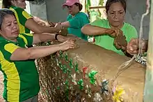 Women in the Philippines use cob and ecobricks to create a wall.  Inside the cob, the plastic is indefinitely secured from degradation for the long term.  Eventually, when the wall comes to its end, the ecobricks can be extricated and reused for another construction