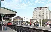 The platforms at East Putney station in September 2006, with a southbound District line train arriving on the left.