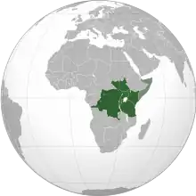 An orthographic map projection of the world, highlighting the East African Community's member states (green) and applicants (light green)