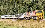 AK carriages being pulled by two DX class locomotives