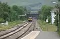 In this picture, taken from Edale station, the eastern portal is seen beyond the departing Manchester-bound train. The route is still semaphore-signalled between Totley Tunnel East and Chinley signal boxes.