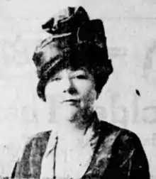 Photo of Edith Rogers wearing a tall, elegant hat and looking directly at the camera.