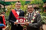 Édouard Fritch, President of French Polynesia, receives the Memorial Plaque in Papeete