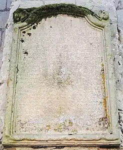 Epitaph on one of the chevet buttresses.