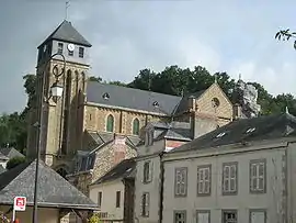 The church in Chailland, with the Rock of the Virgin at top right