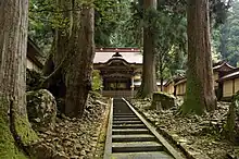 Building off in the distance in a forest