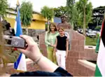 Descendants of Palestinians take a picture beside a bust of Yasir Arafat, San Salvador