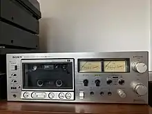 An image of an elcaset el-5 tape deck in metallic chrome with large VU metres