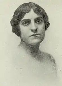 A young white woman with short dark wavy hair.