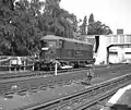 Electric locomotive at Acton Town. This shows an example of the class of 20 electric locomotives introduced by the Metropolitan Railway from 1922 onwards. The example shown here is No. 12, Sarah Siddons.