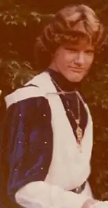 Actor in Elizabethan costume with tunic, medallion, and cape