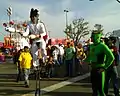 An elvis impersonator performing at Borderfest 2008 while the Green Ghost looks on