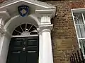 Plaques outside the embassy depicting the Coat of arms of Kosovo