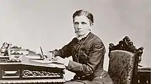 emmeline b wells writing at a desk