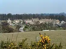 Village, seen from a distance across a field