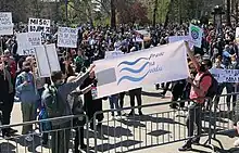 Demonstrators holding banners in Belgrade on 10 April 2021