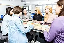 Group of students in conversation with a lecturer