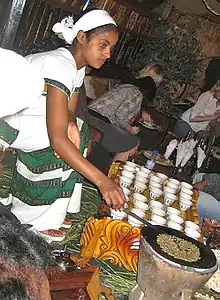 Image 23An Ethiopian woman preparing Ethiopian coffee at a traditional ceremony. She roasts, crushes, and brews the coffee on the spot. (from Culture of Africa)