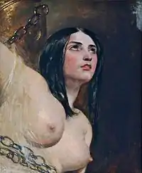 topless woman chained to a rock