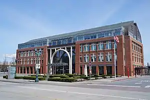 A four-story building with a prominent arch at the front entrance