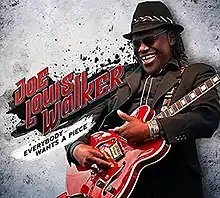 Joe Lewis Walker, playing a red electric guitar