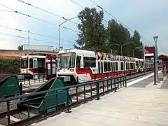 The side platform and an island platform of Expo Center station with two trains waiting