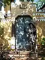 The gate outside Big foot museum with the statue of a guarding soldier.