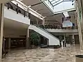 Section of the mall that expanded in 1997-1999 from one to two levels.  The old layout only had a lower level with the escalators going up to a higher one level section.  After 1999, the section in front of the escalators expanded to two floors.