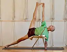 photo of yoga teacher demonstrating use of props for alignment