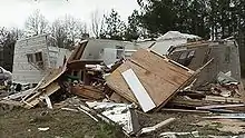 At this intensity, tornadoes have a more significant impact on well-built structures, removing the roofs, and collapsing some exterior walls of poorly built structures. F2 tornadoes are capable of completely destroying mobile homes and generating large amounts of flying debris. This home completely lost its roof, but its walls remained intact.