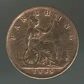 A copper coin with Britannia on it