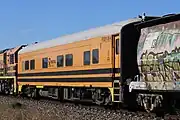 Crew car FDDY 5 (former Bluebird railcar 256 ‘Kookaburra’) on an Aurizon grain train at Yumali, April 2023.