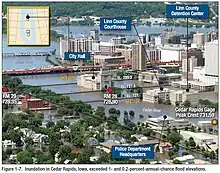 Flood water of Cedar River is over several main street bridges and up to the windows of several public buildings such as the courthouse and city hall.